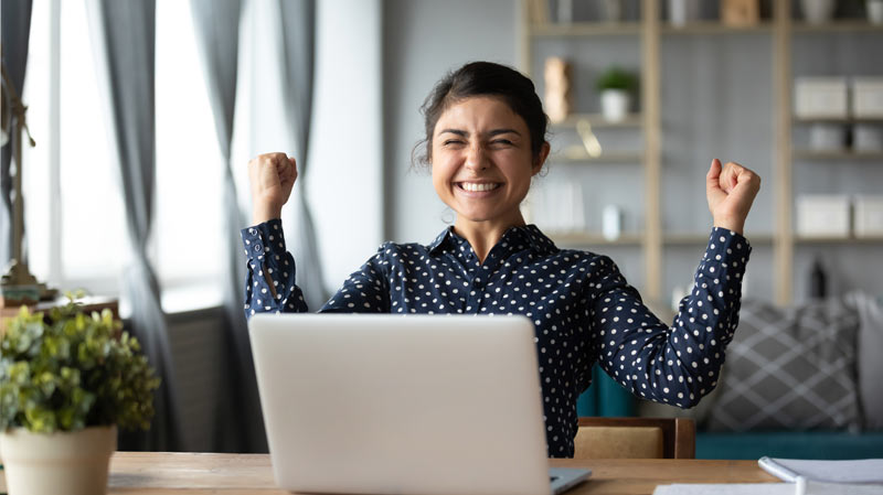 girl cheering at computer 