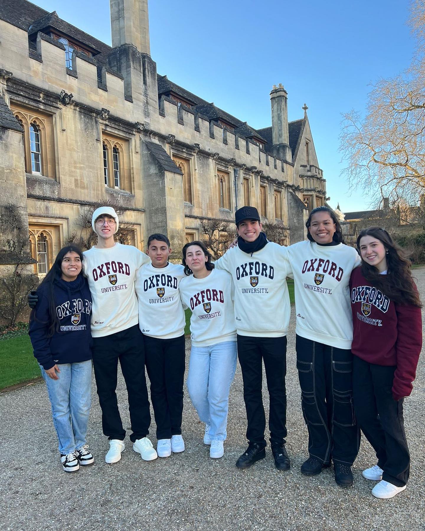 A group of students posing for a photo. They are all wearing Oxford University sweatshirts
