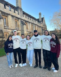A group of students posing for a photo. They are all wearing Oxford University sweatshirts