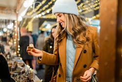 a young woman shopping at a market stall
