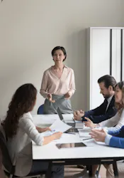 Lady in class with three people at desk