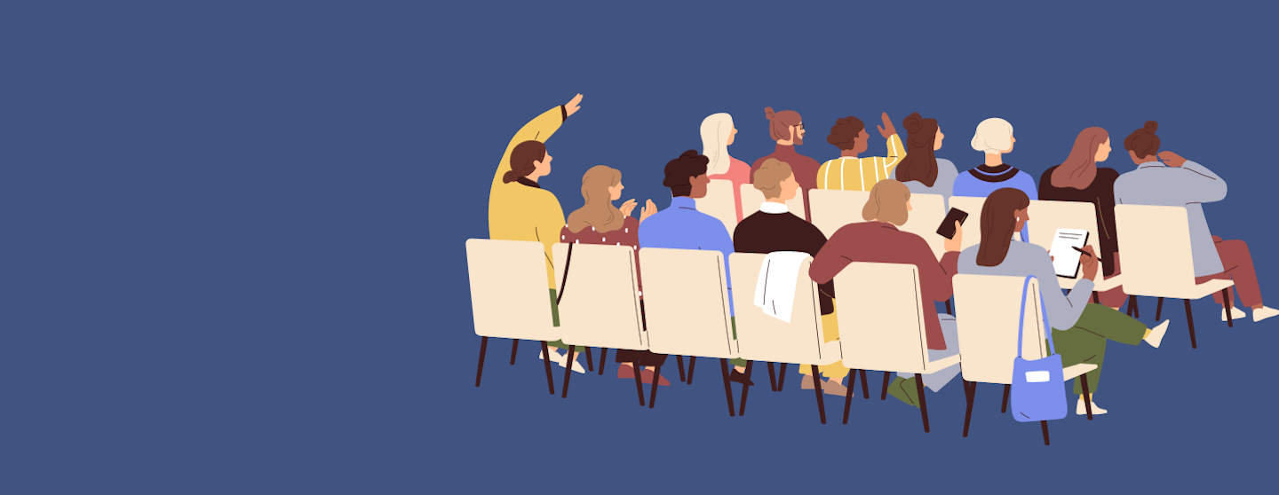 people sitting on chairs in a conference 