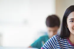 Girl sitting at desk in classroom