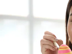 Girl painting Easter egg