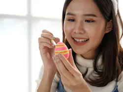 Girl painting Easter egg