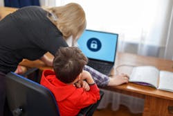 lady helping child at laptop 