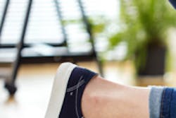 student kneeling on suitcase