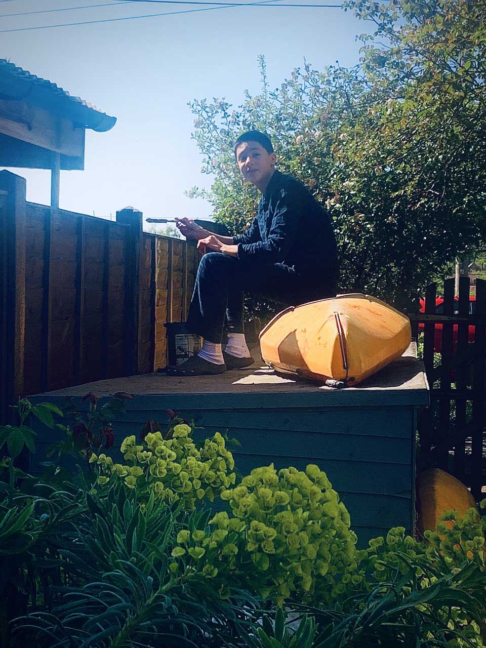 Student painting fence