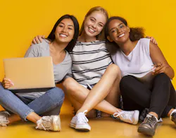 Students sitting smiling crossed legs