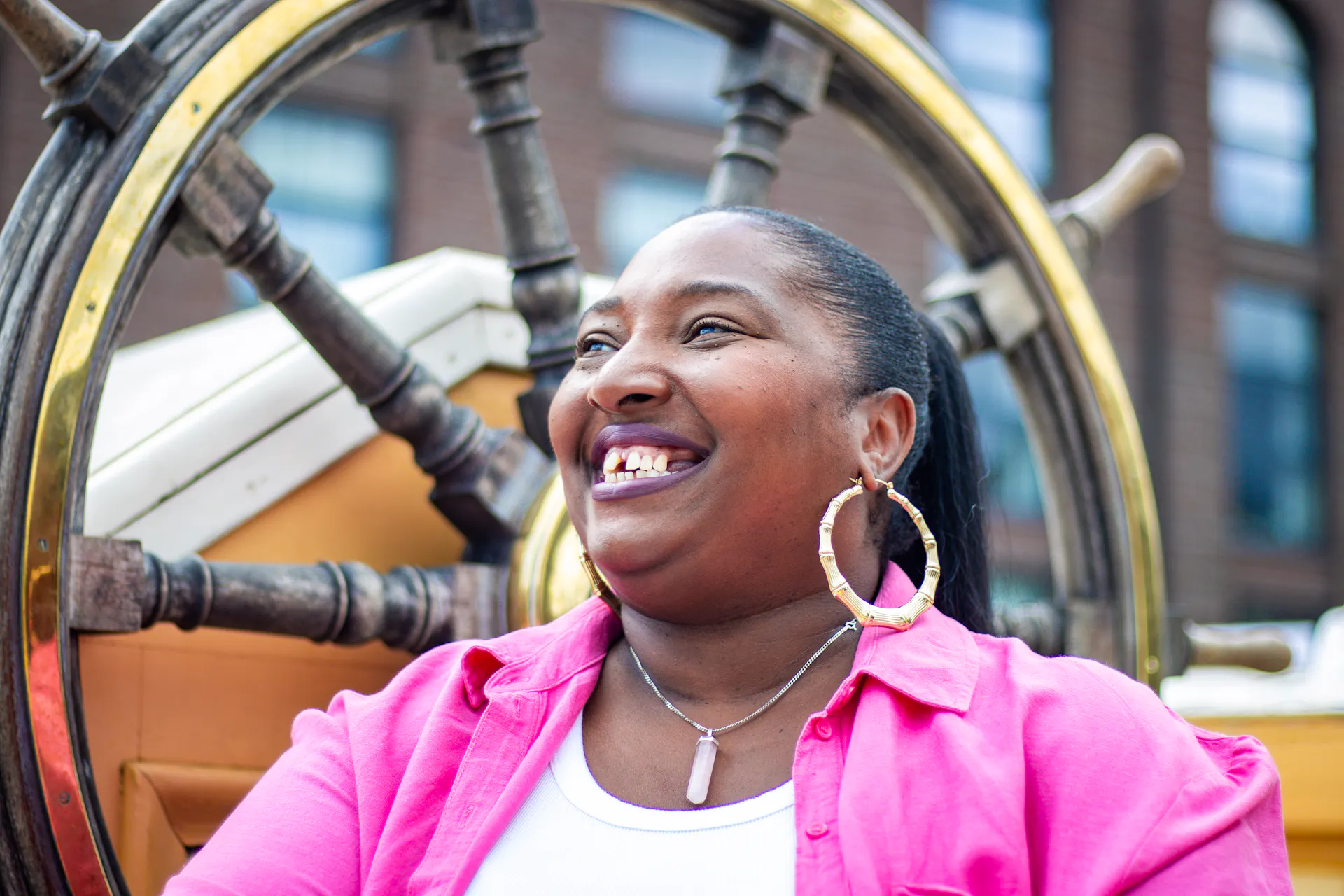 Shani on the weather deck next to the ship's wheel