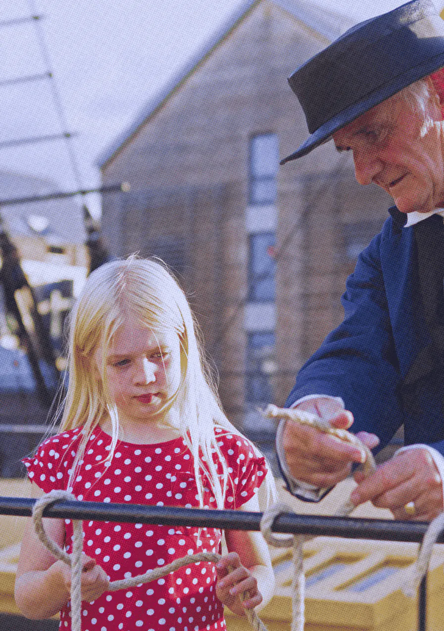 Member and child on weather deck of ship
