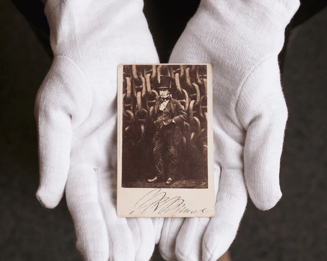 Gloved hands holding a photograph of Isambard Kingdom Brunel from the Bristol Dockyards' collection