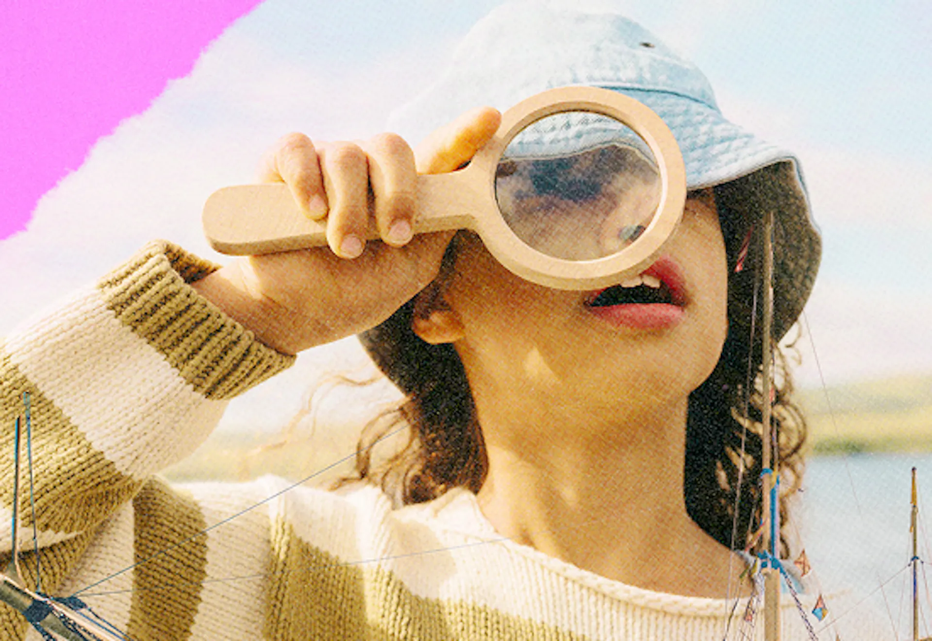 child looking through magnifying glass 