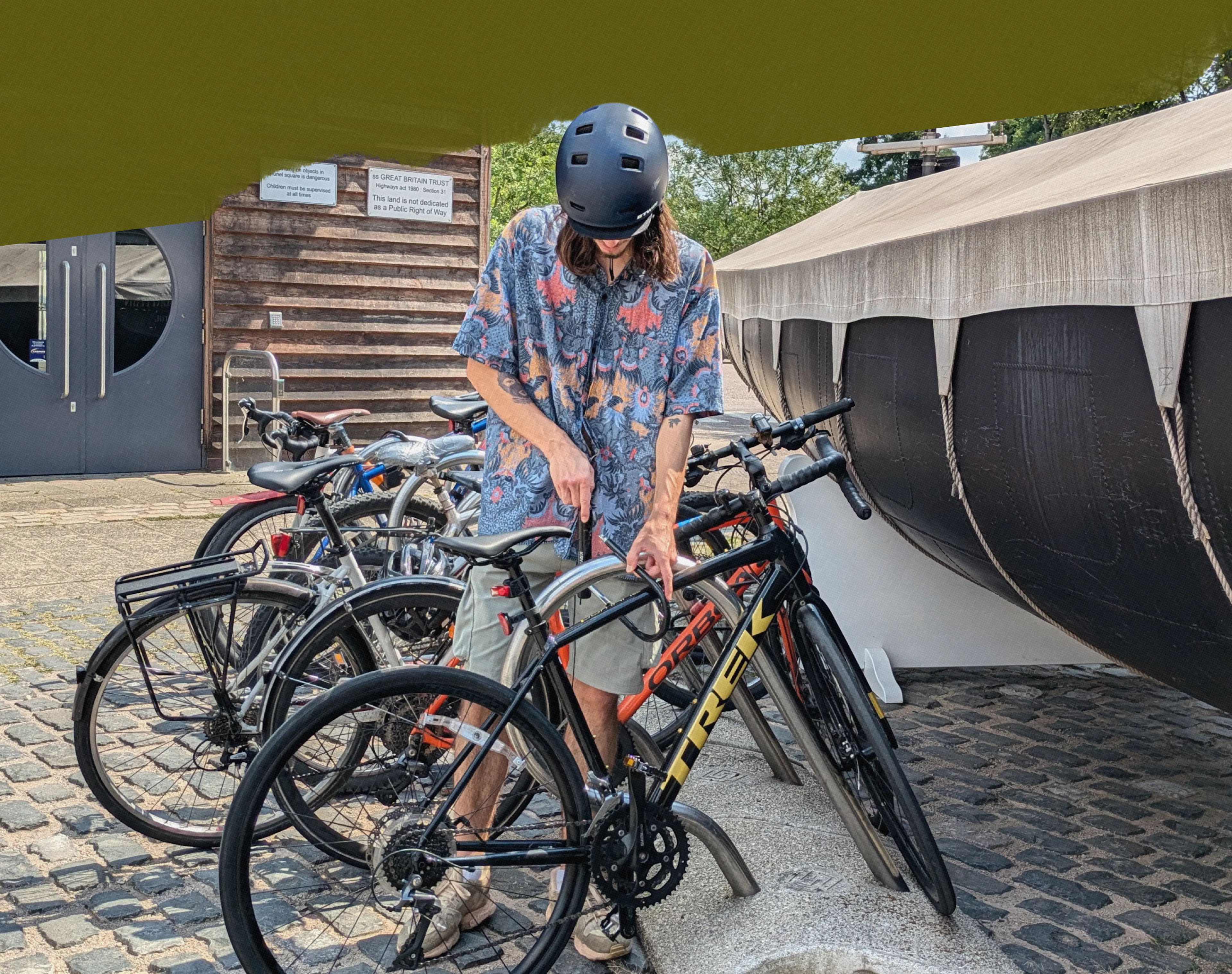 Bristol Dockyards cyclist mounting bike to bike rack 