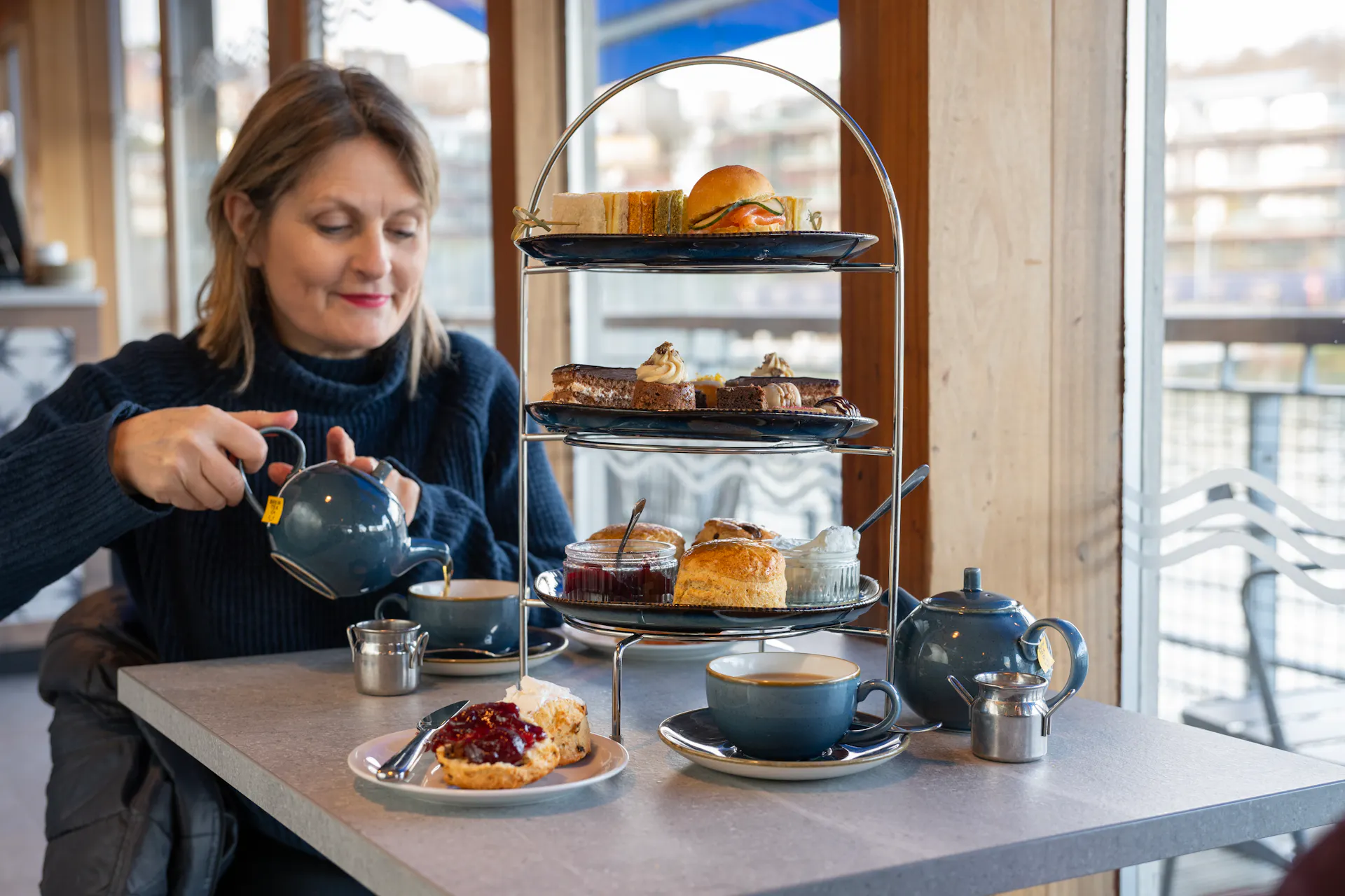 Woman enjoying her Afternoon Tea at the Board Walk on Bristol Dockyards