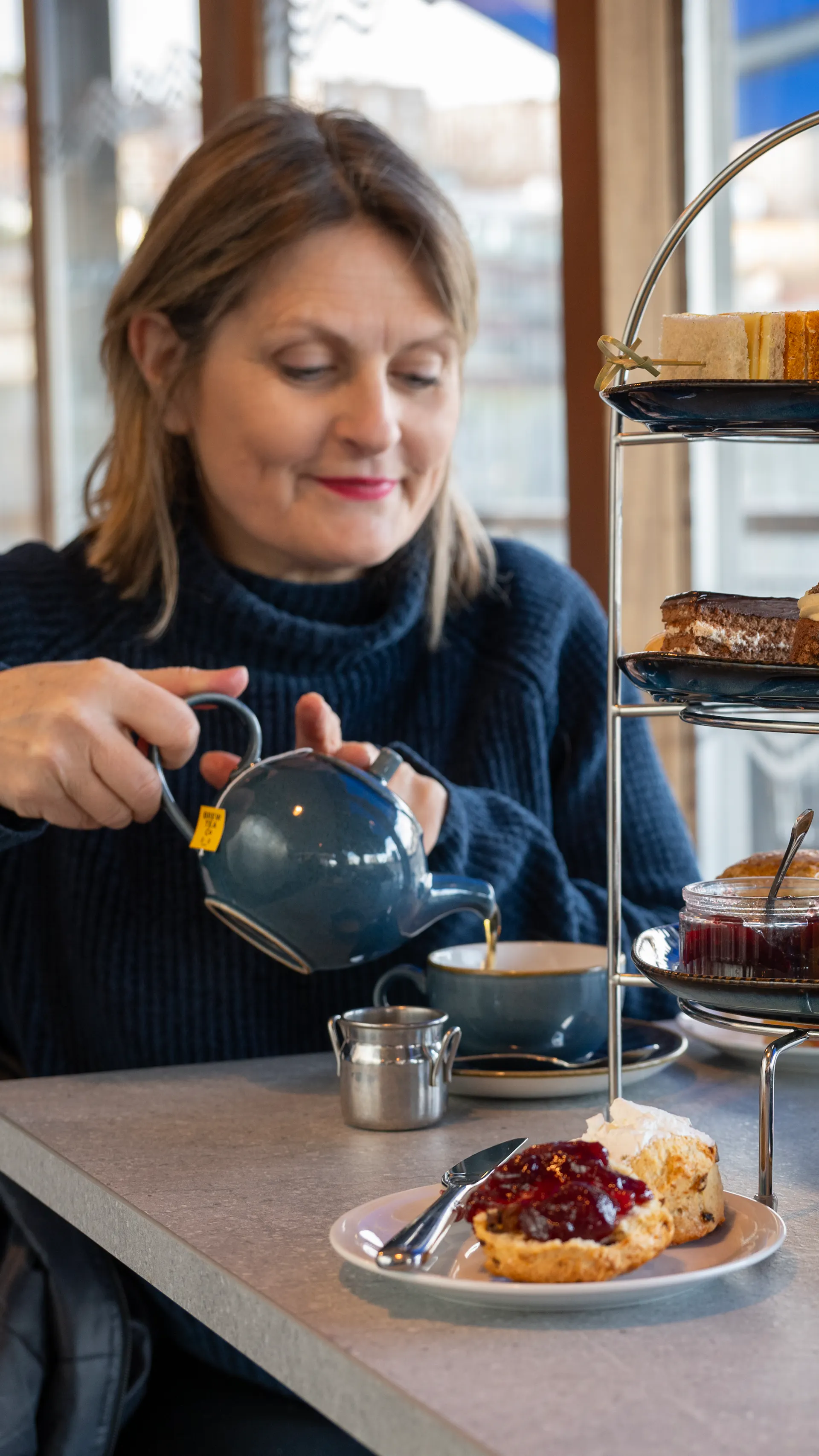 Woman enjoying her Afternoon Tea at the Board Walk on Bristol Dockyards 