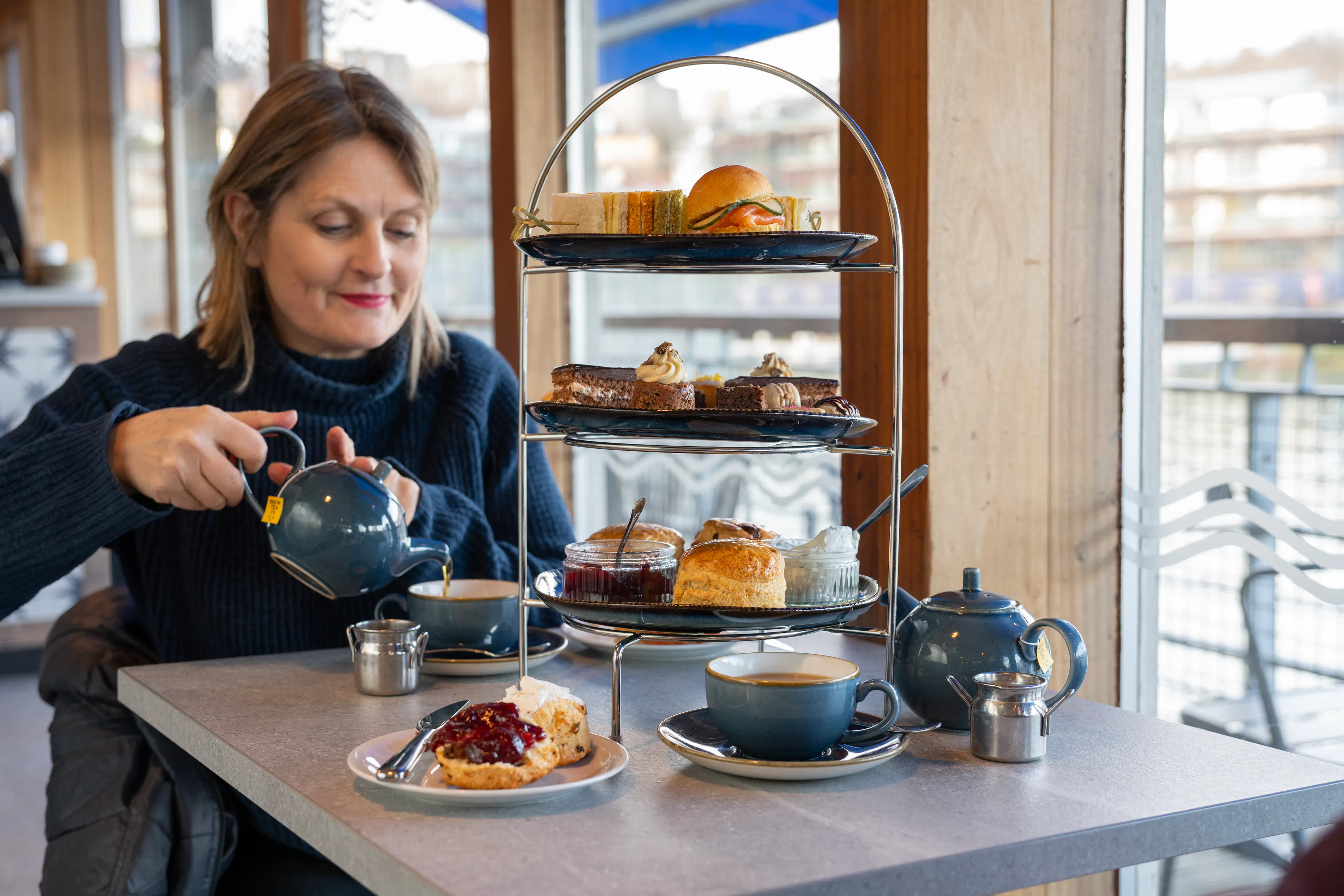 Woman enjoying her Afternoon Tea at the Board Walk on Bristol Dockyards 