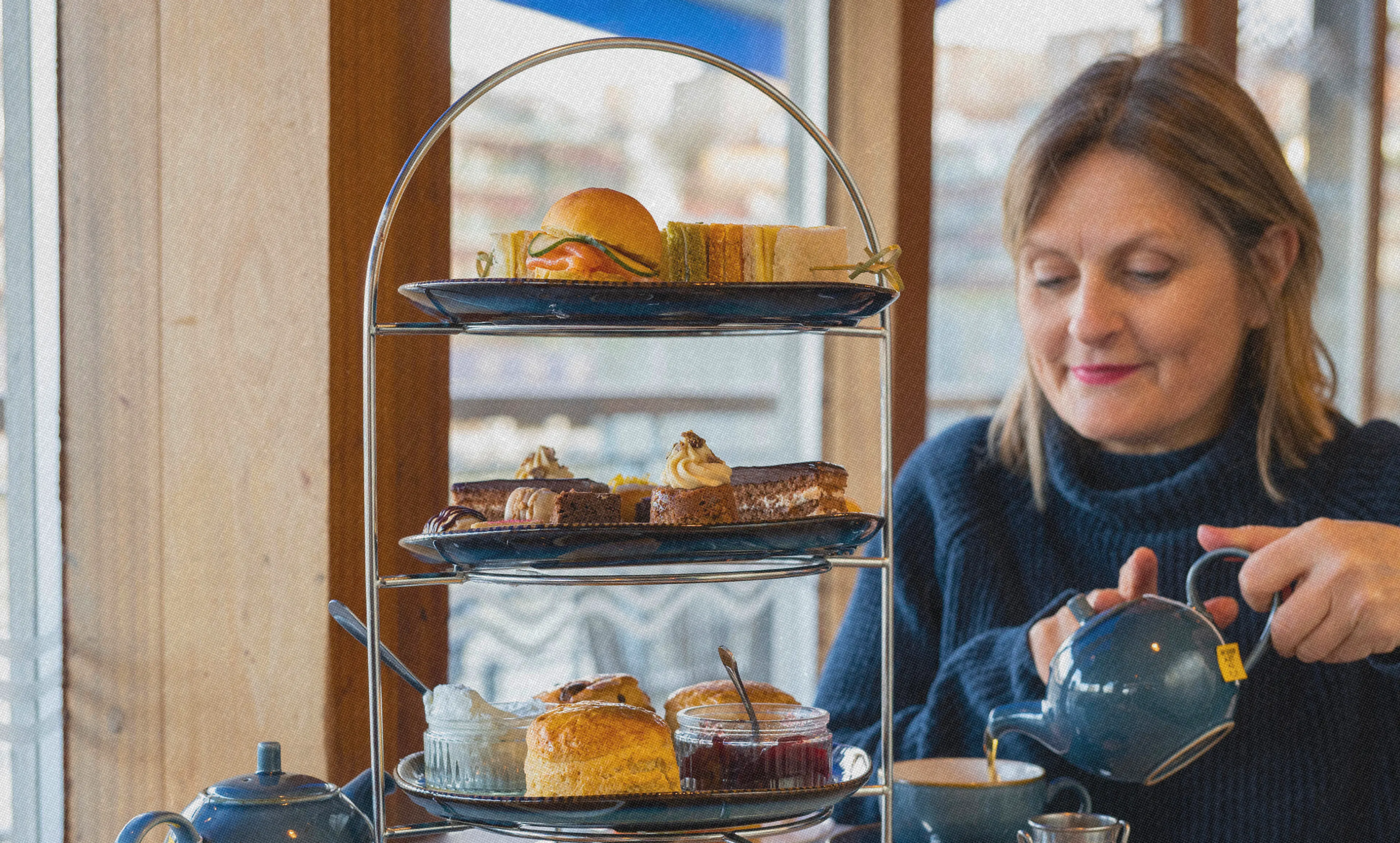 Woman enjoying her Afternoon Tea at the Board Walk on Bristol Dockyards 