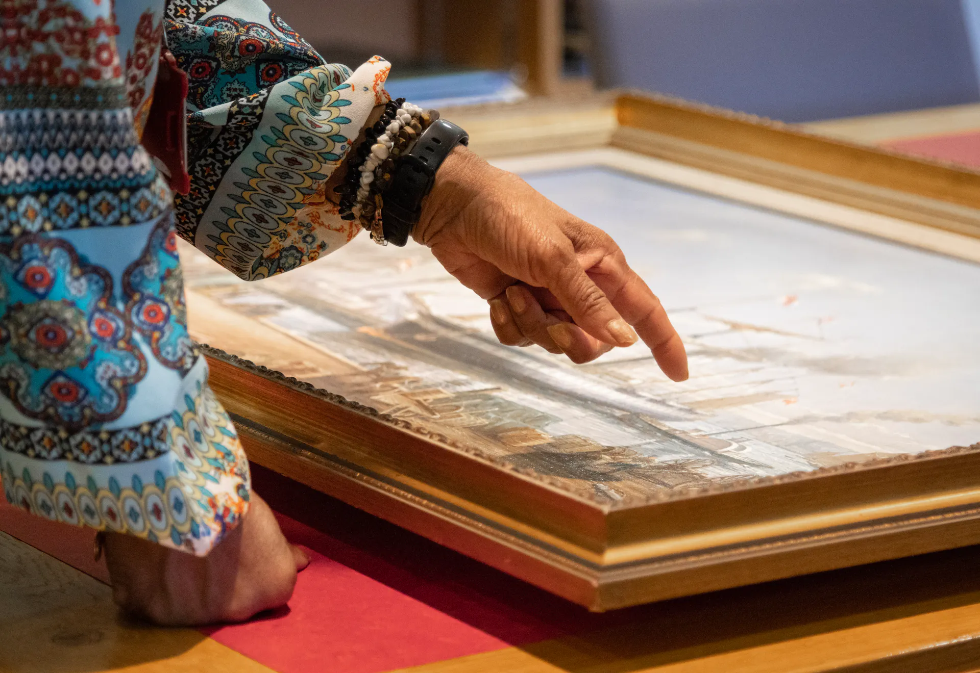 Woman pointing at painting artefact in the Brunel Institute at Bristol Dockyards 