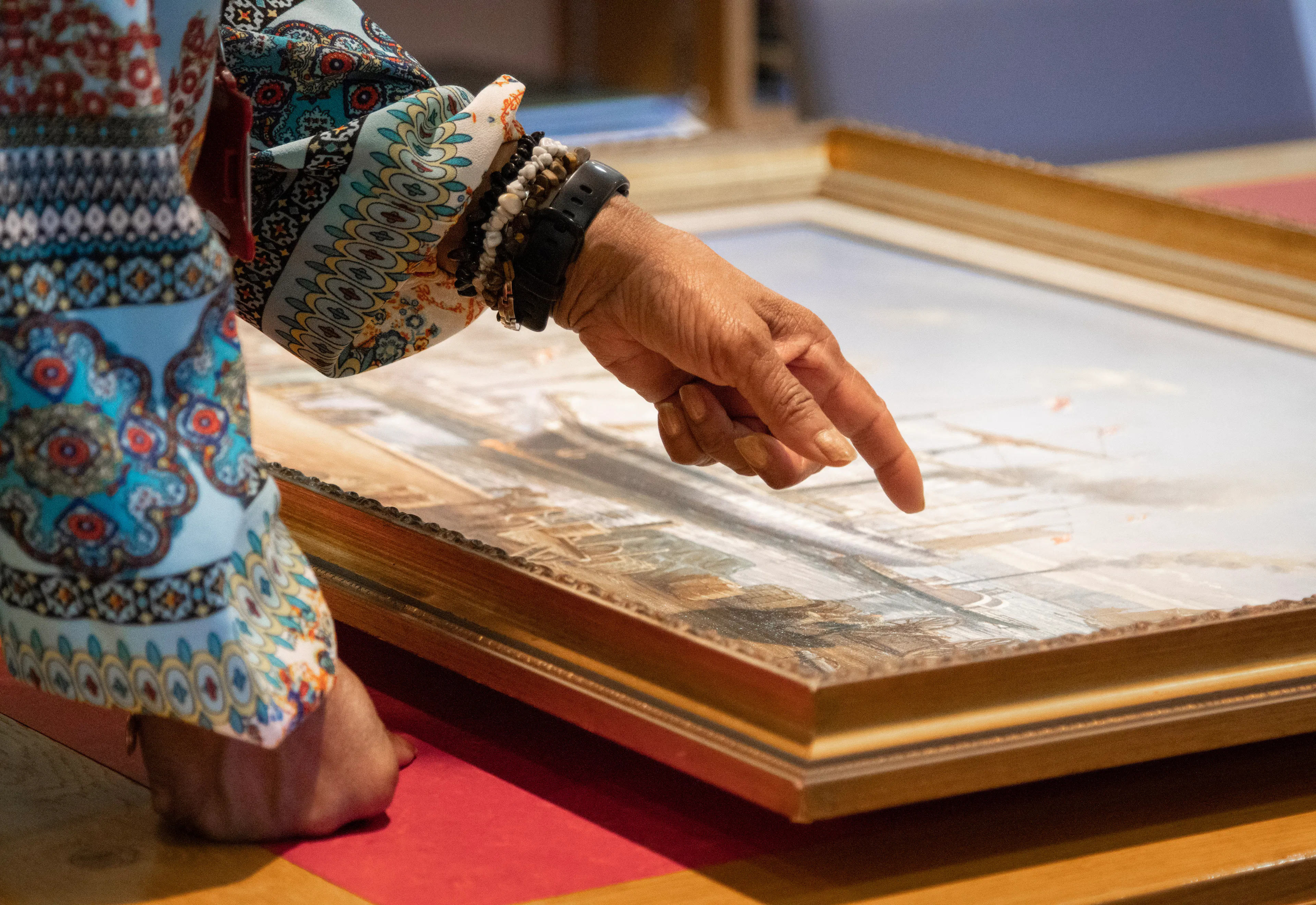 Woman pointing at painting artefact in the Brunel Institute at Bristol Dockyards 