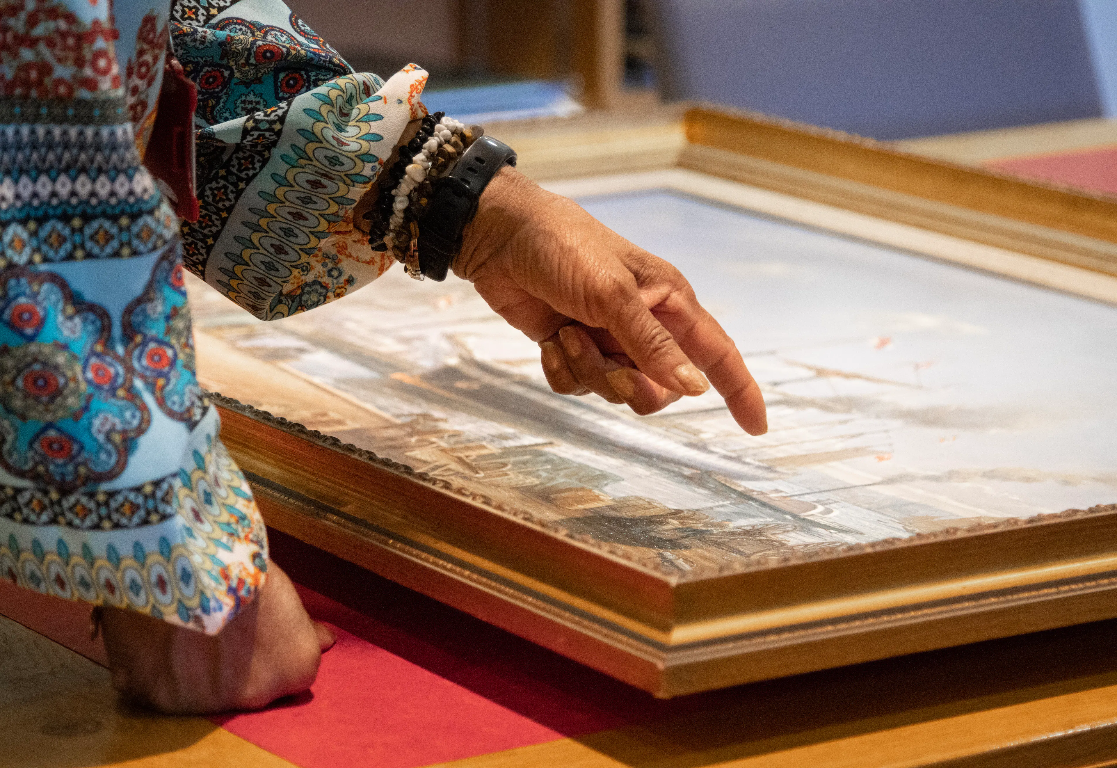Woman pointing at painting artefact in the Brunel Institute at Bristol Dockyards