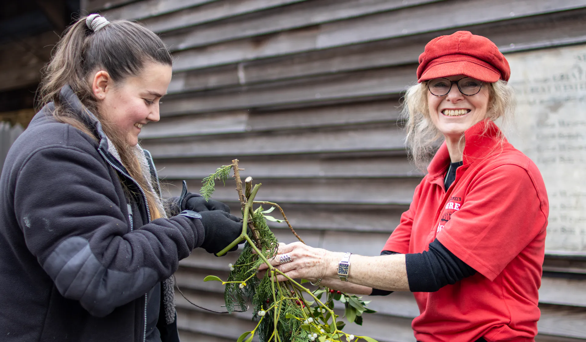 A volunteer helps decorate the site for Christmas