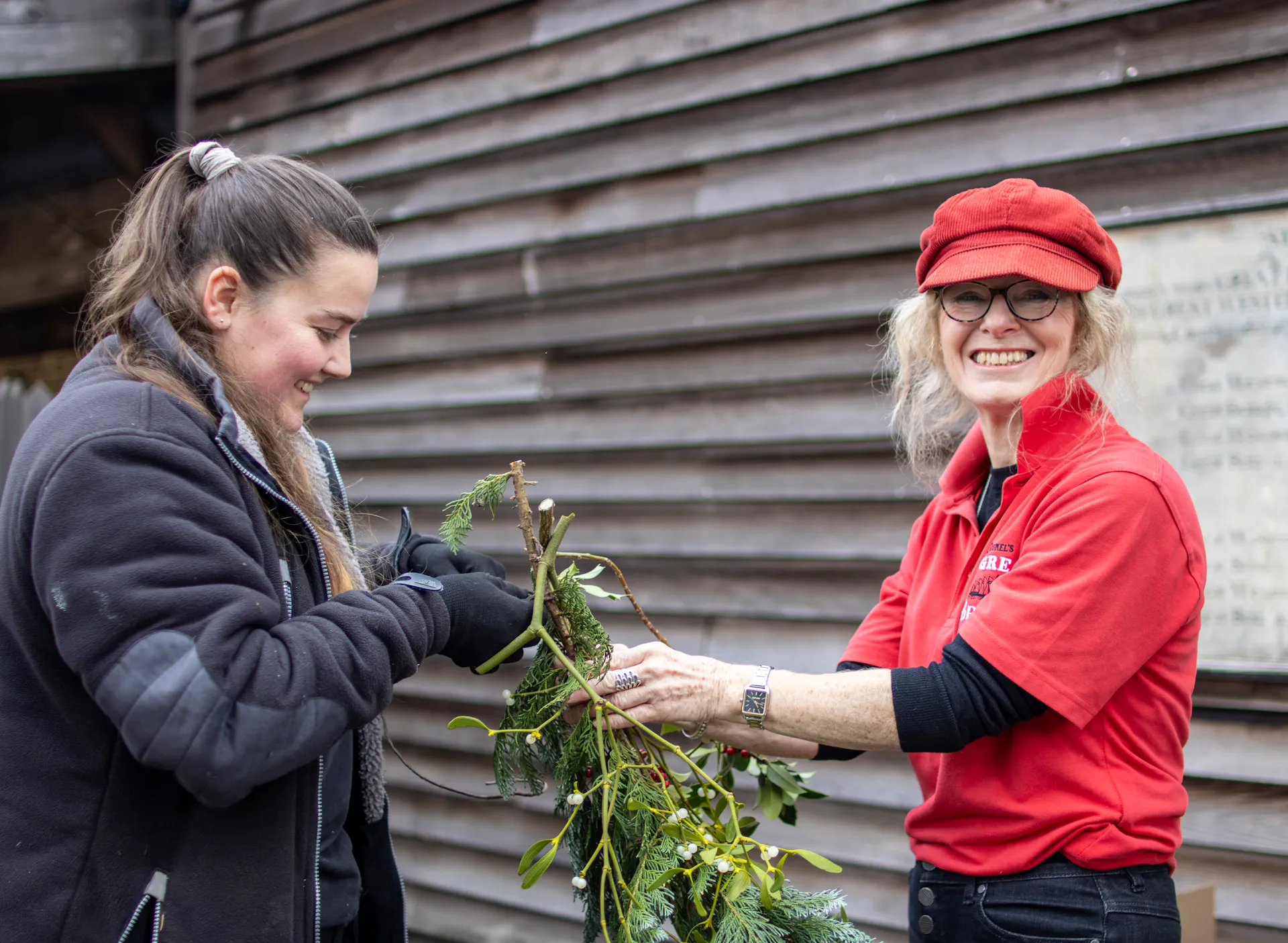 A volunteer helps decorate the site for Christmas 