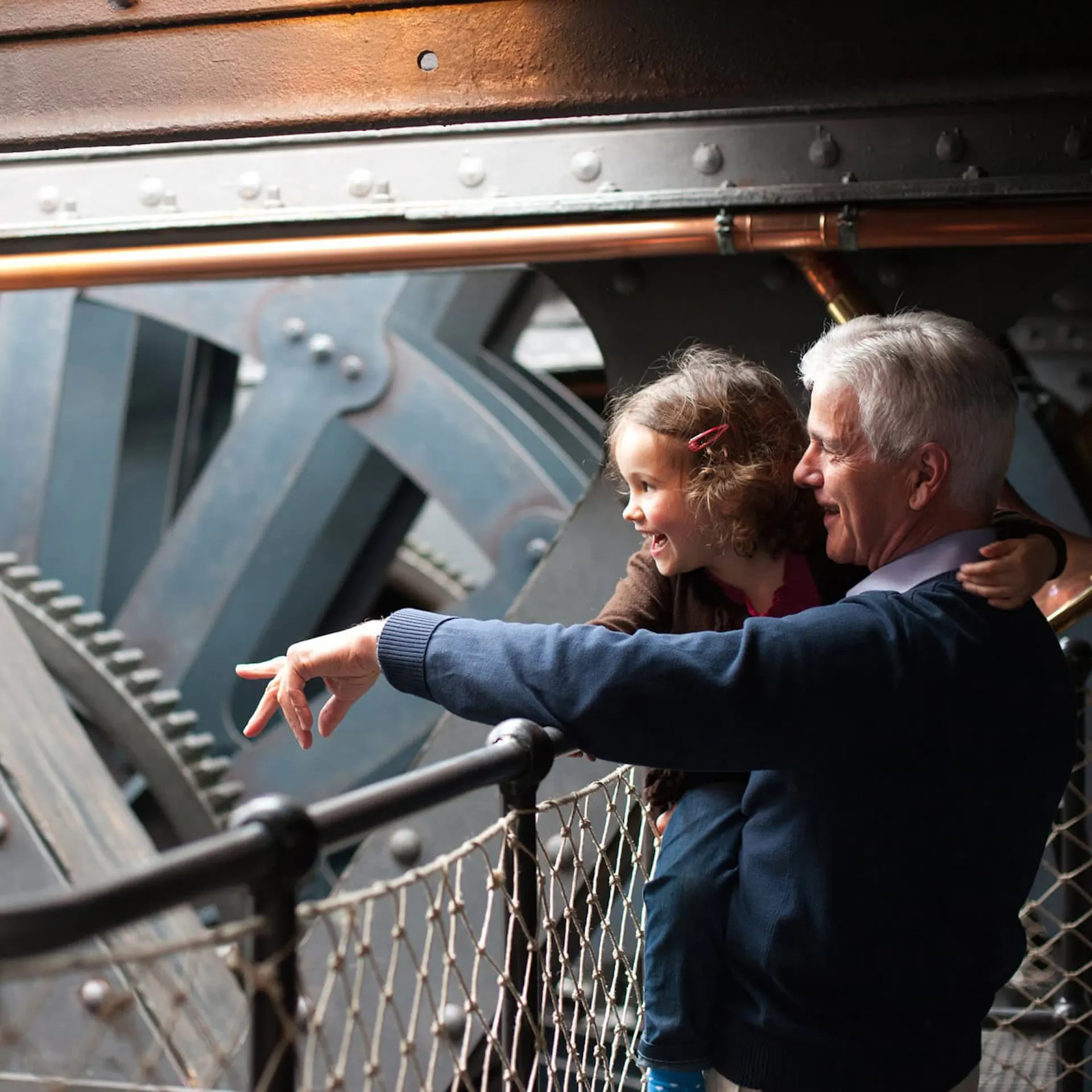 Grandparent and child in the engine room at Bristol Dockyards