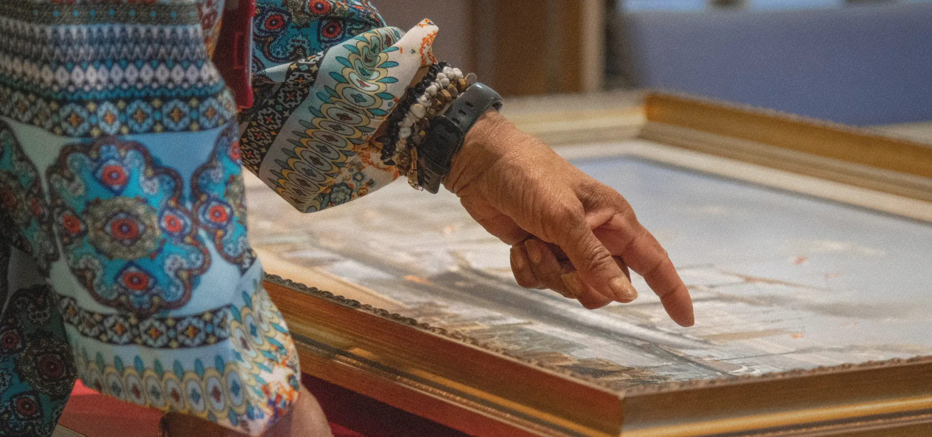 Woman pointing at painting artefact in the Brunel Institute at Bristol Dockyards