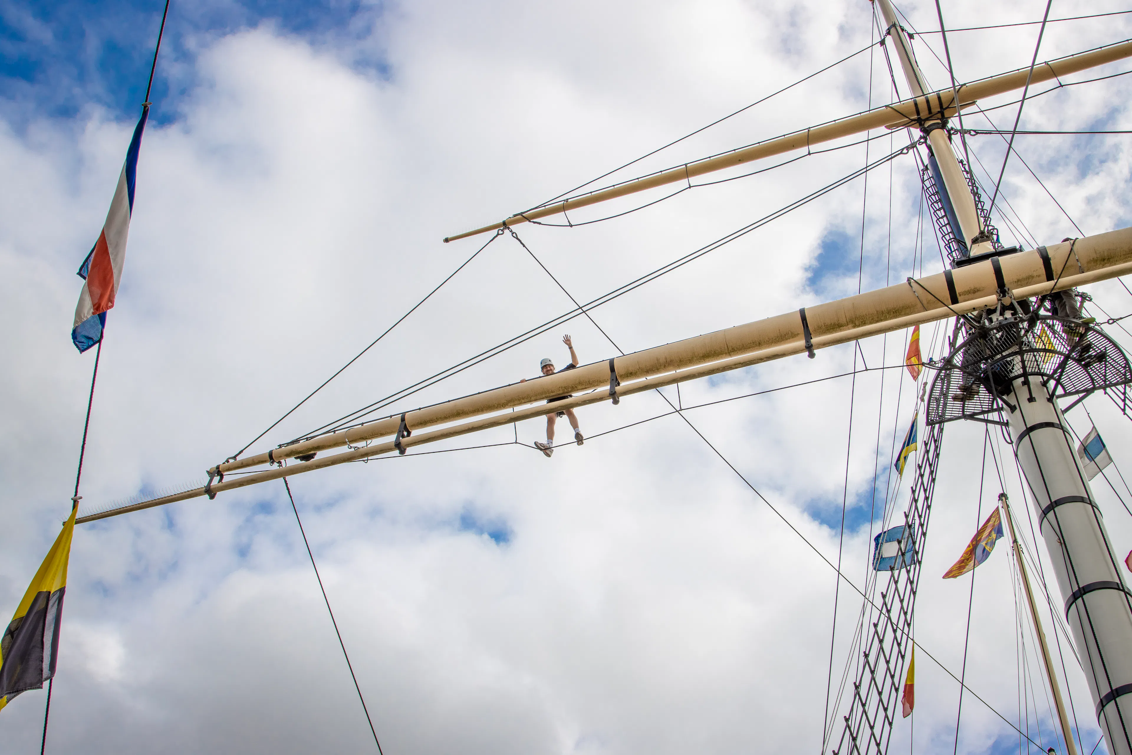 Someone at the top of the ship's rigging in Go Aloft