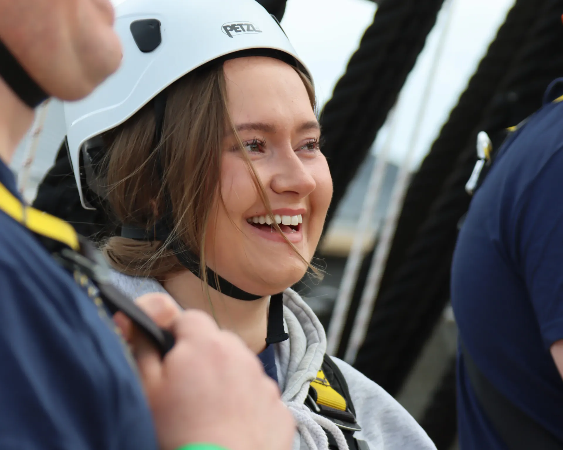 Someone with climbing gear on about to complete 'Go aloft'