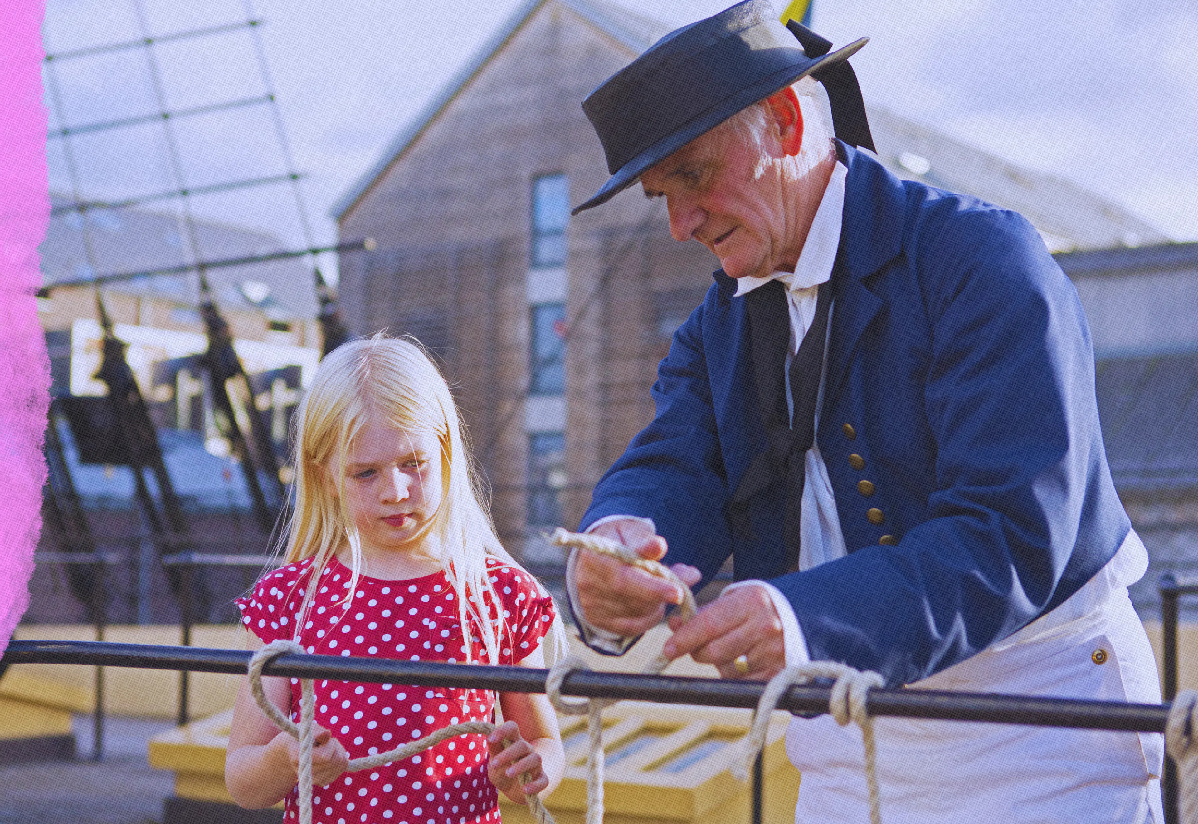 Member and child on weather deck of ship