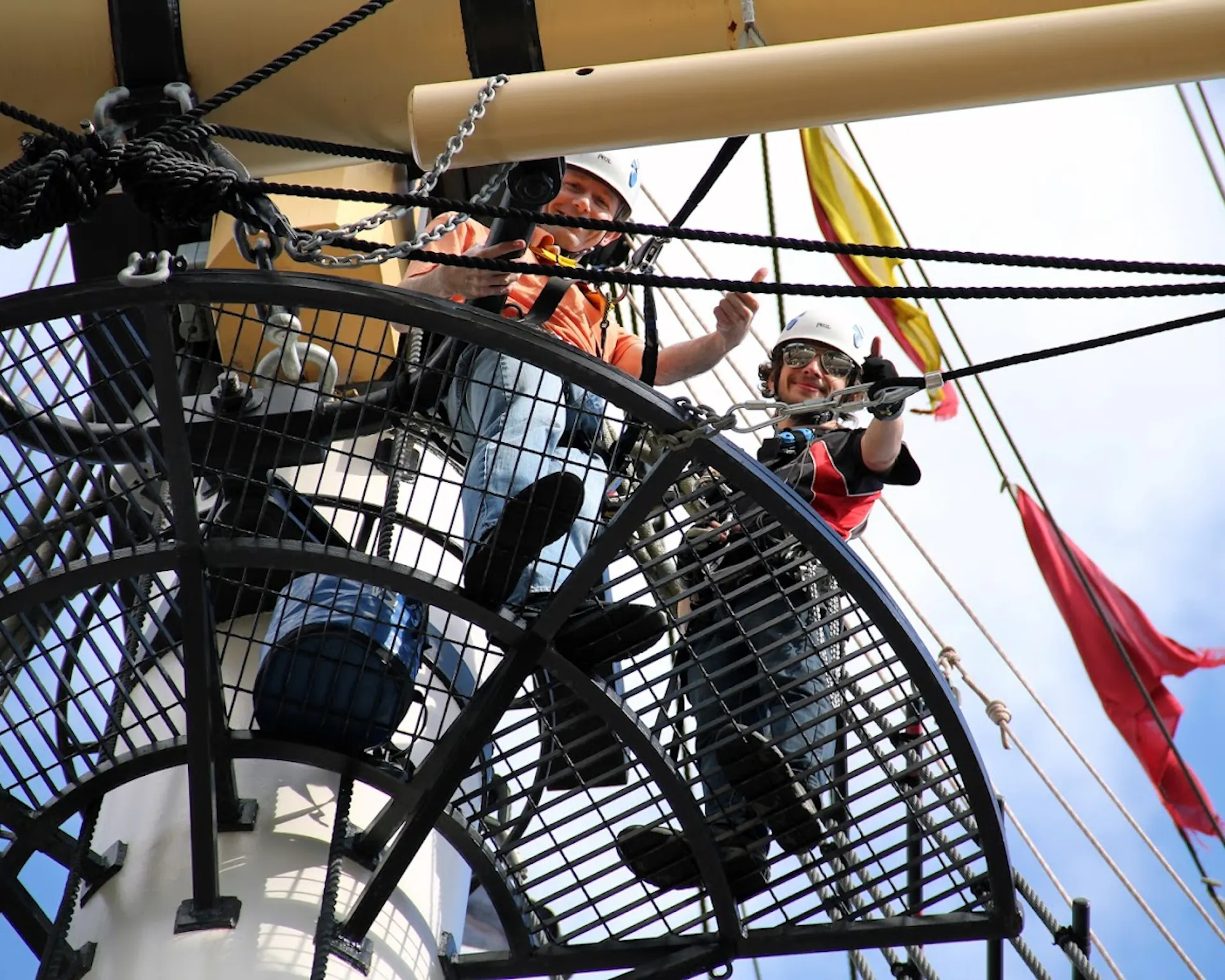 Two people at the top of Go Aloft giving a thumbs up 