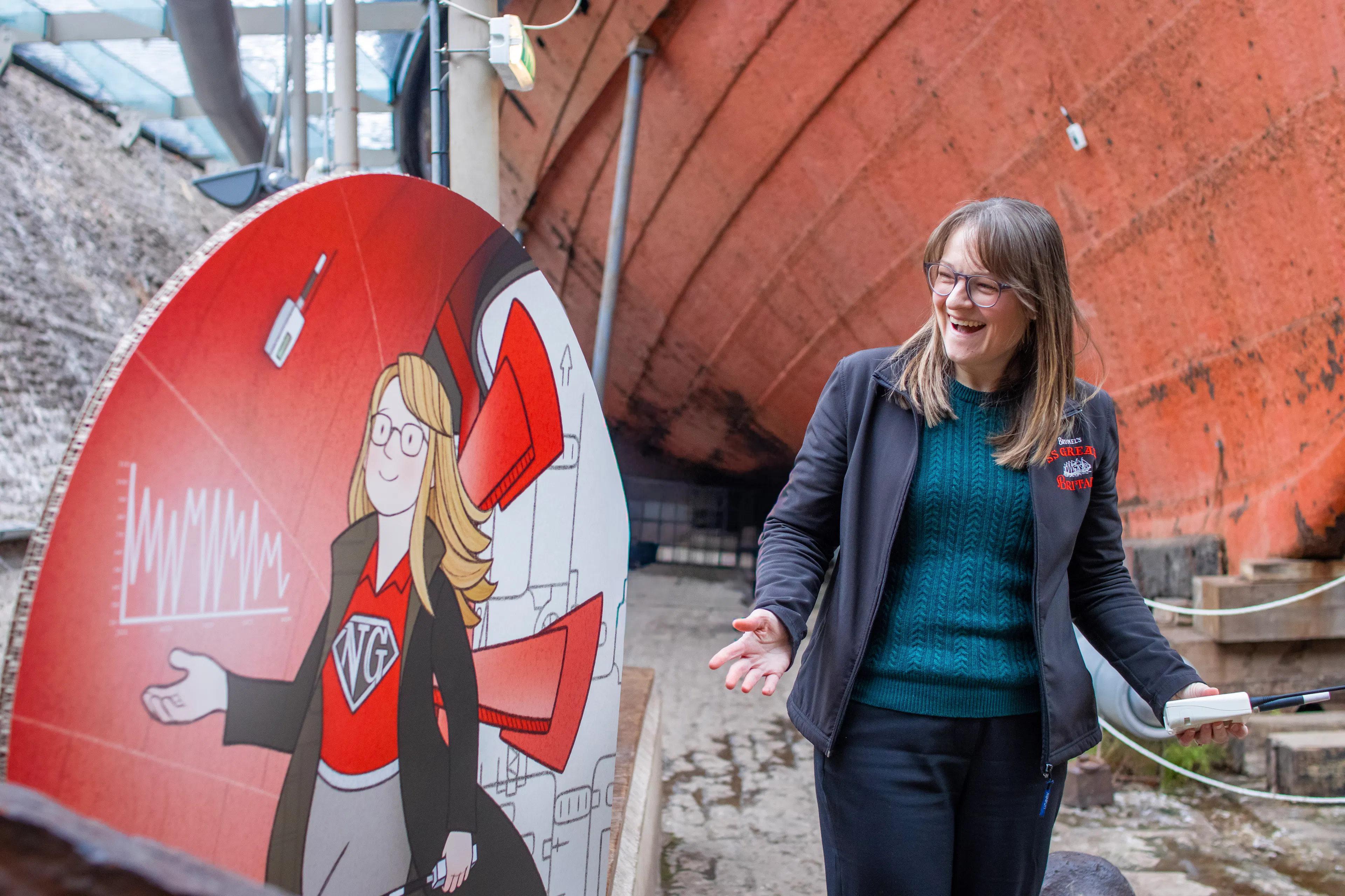 Ship's scientist Nicola Grahamslaw stands opposite a cardboard cutout of herself looking surprised 