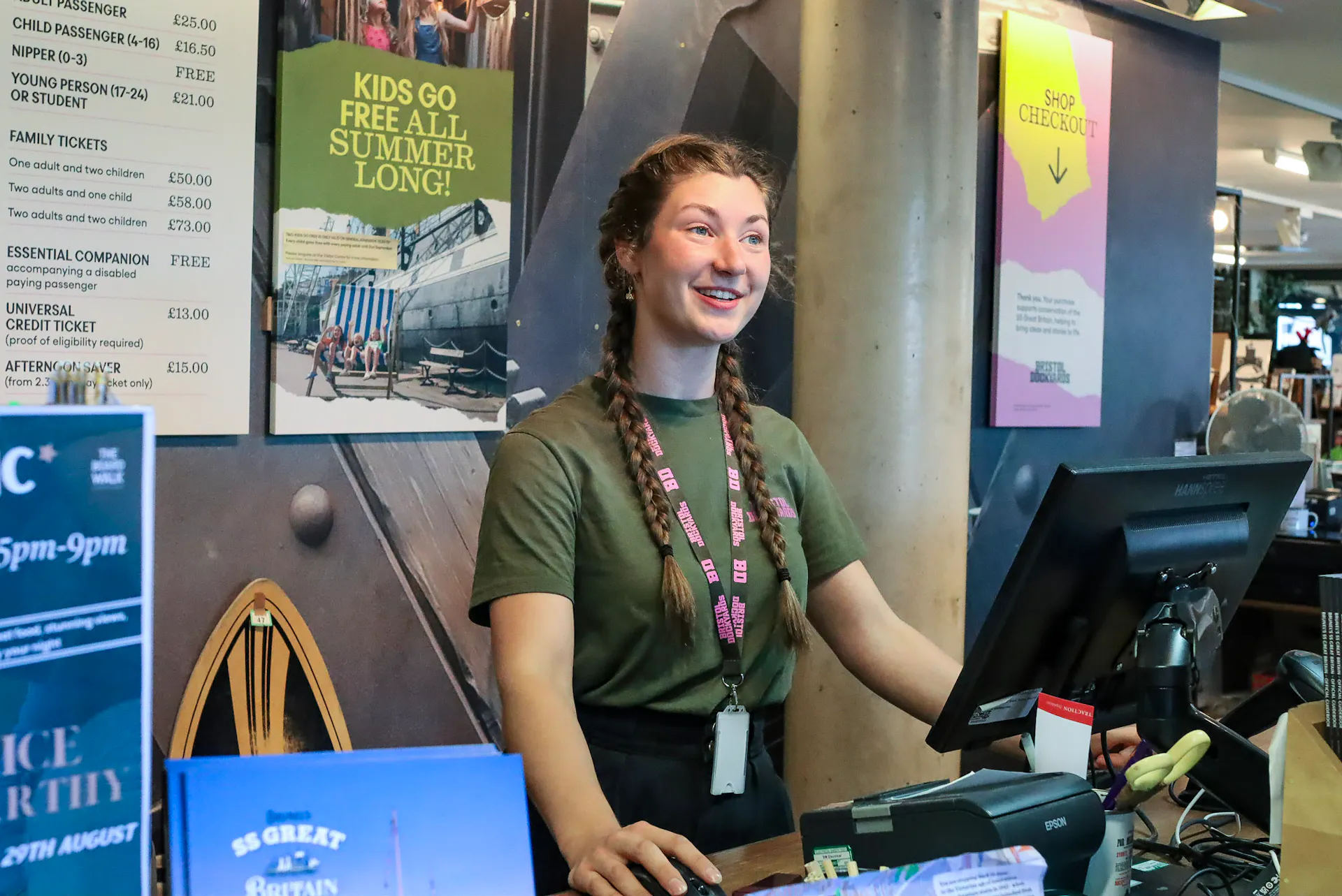 A staff member welcoming visitors at the front desk