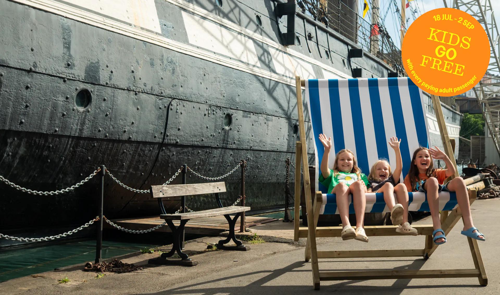 Kids on a deck chair by the SS Great Britain