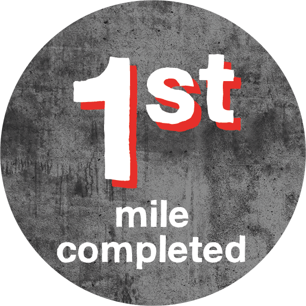 white text saying 1st mile completed with red highlight on dark grey background