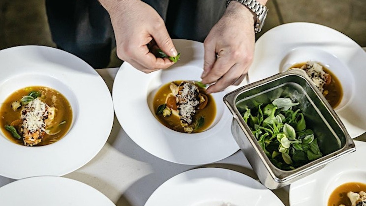 Ocean to Garden Dinner - dinner plate being prepared by chef
