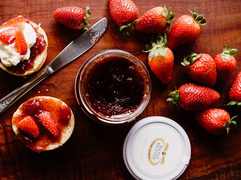 flatlay of scones, jam and strawberries