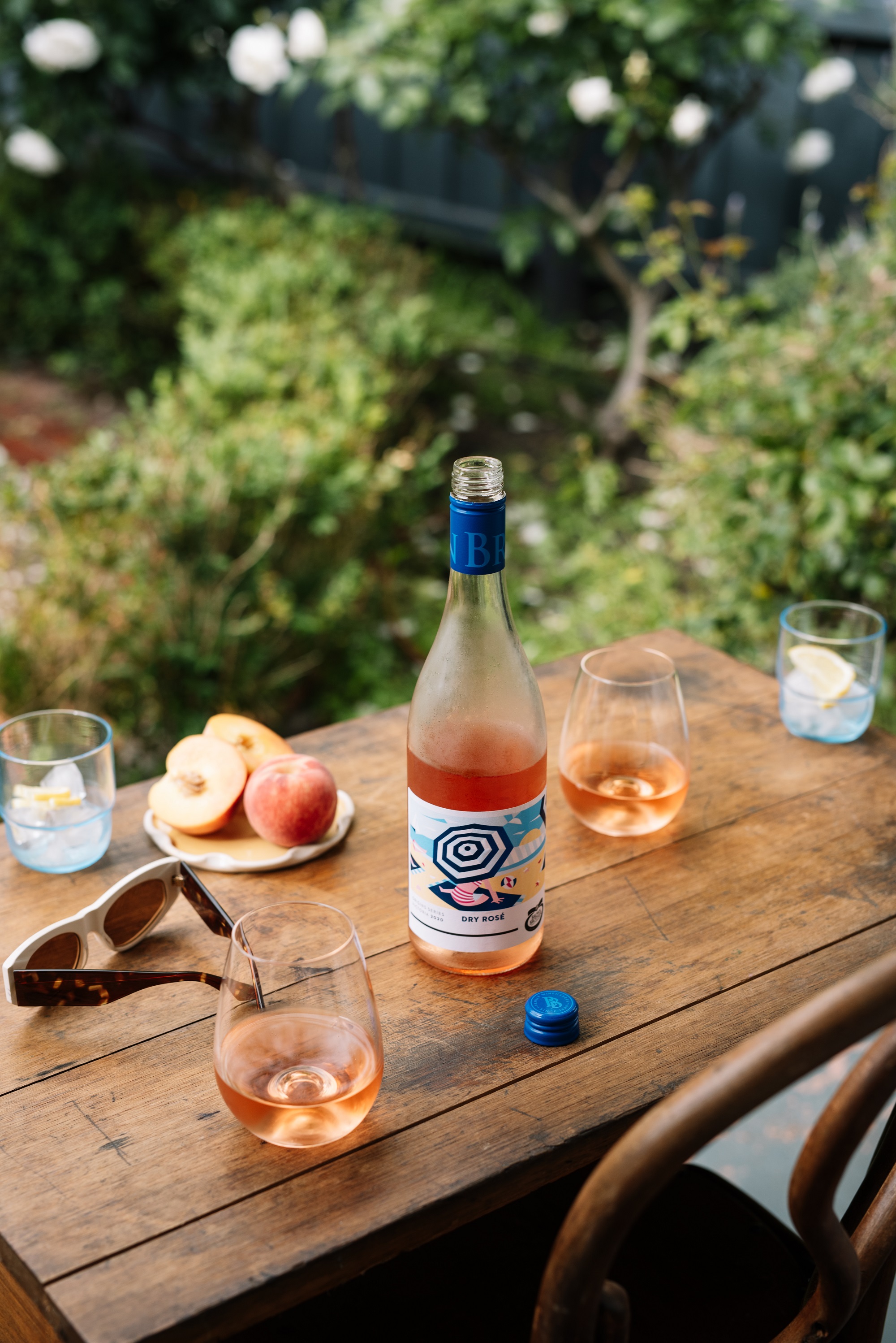 bottle of Origins Series Rose and fresh fruit outdoors