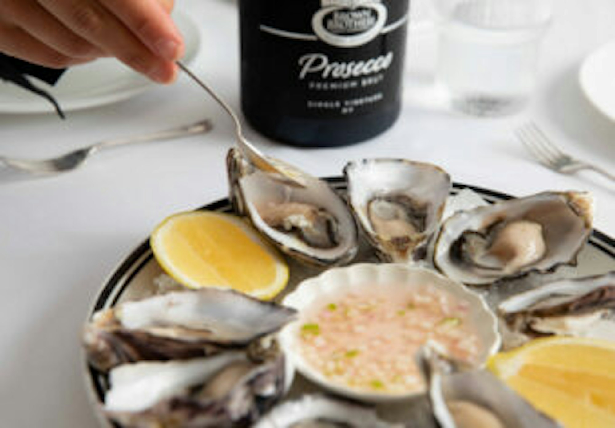 Plate of fresh oysters with a bottle of Brown Brothers Prosecco Premium Brut 
