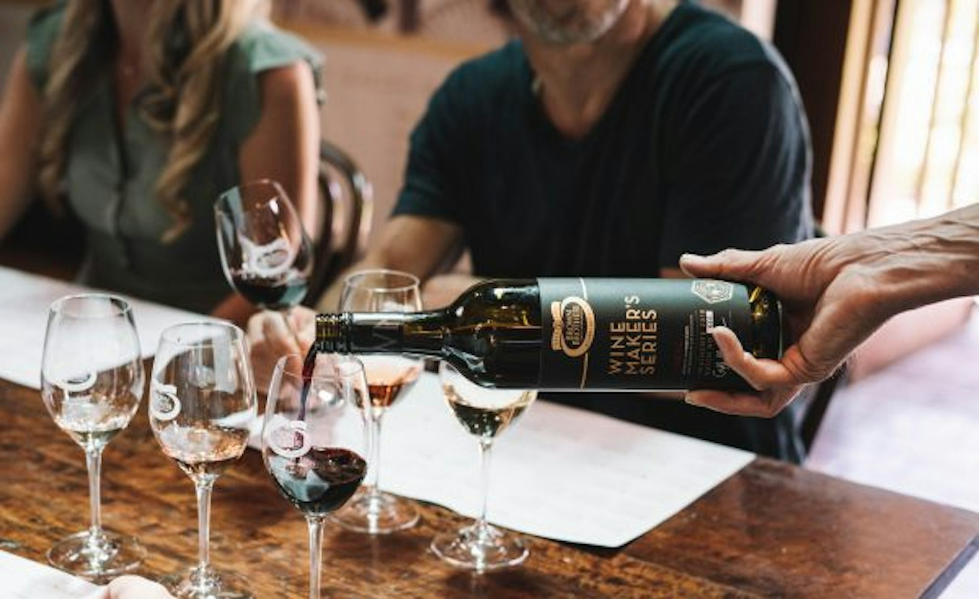 Person pouring Brown Brothers Winemaker's Series into a glass