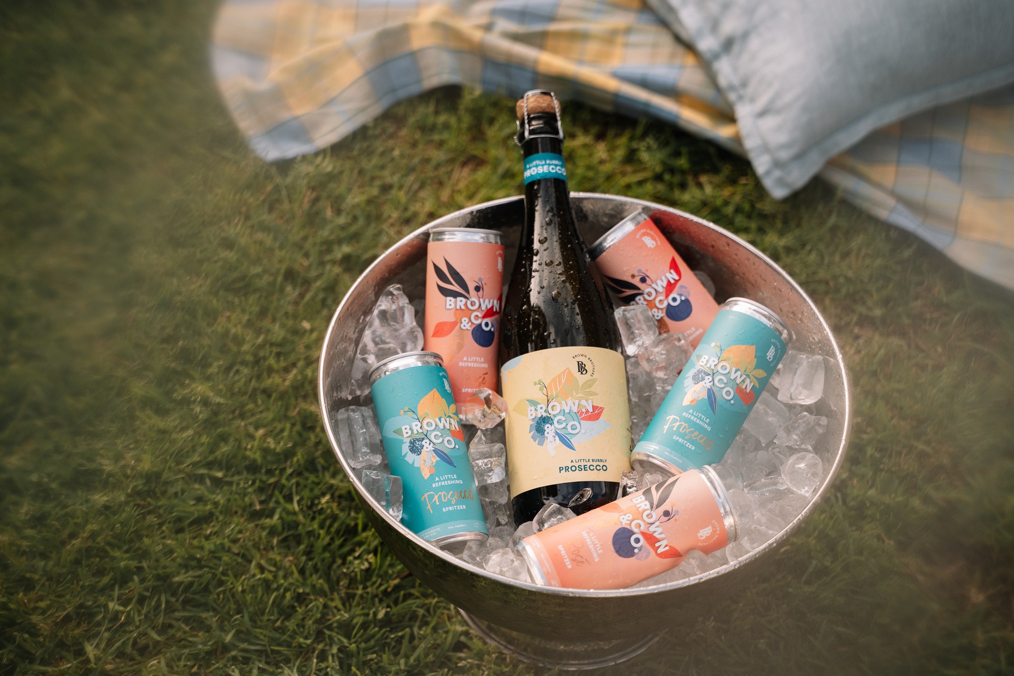 Brown & Co. Prosecco and cans in an ice bucket