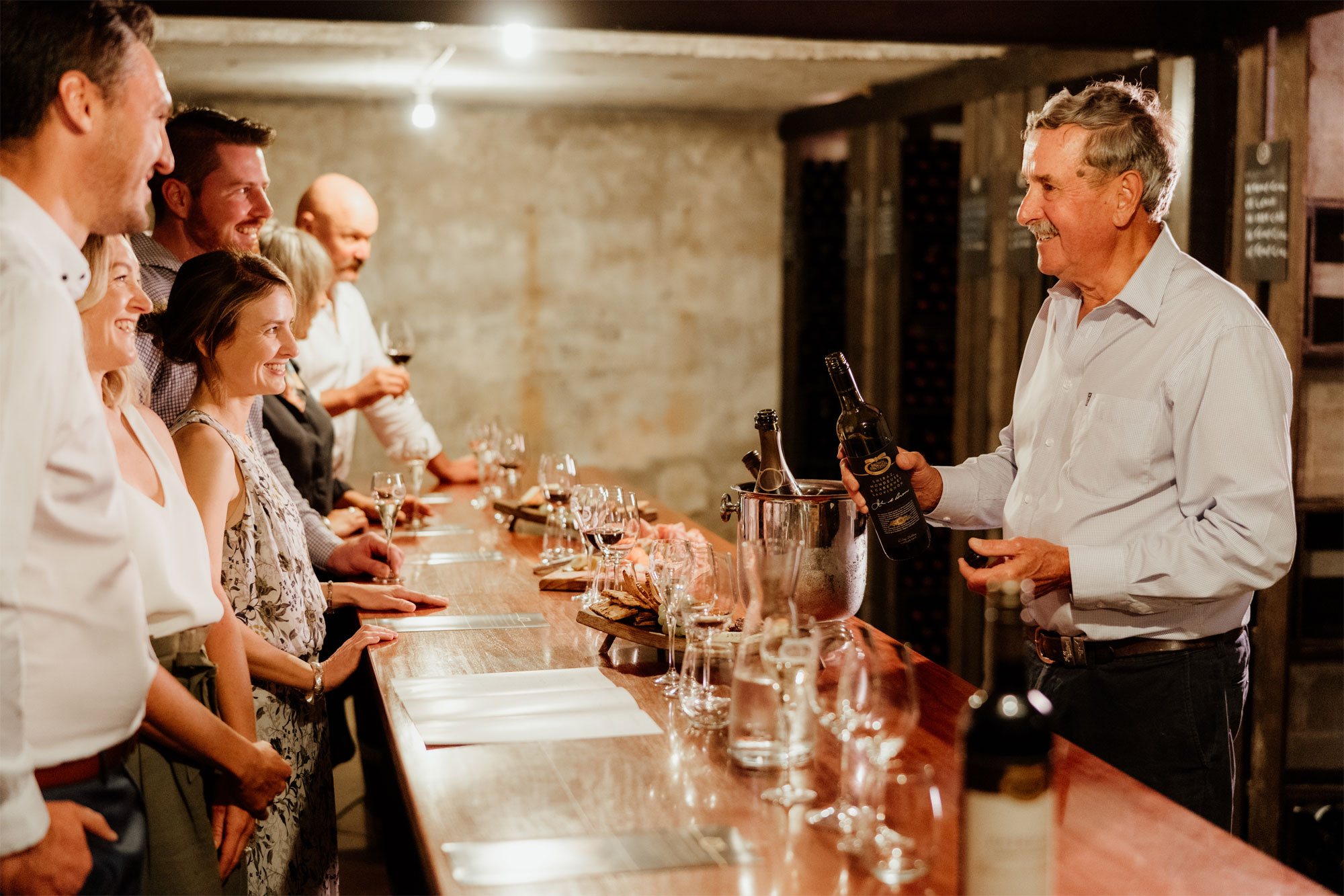 Group of friends enjoying private tasting in Family Cellar