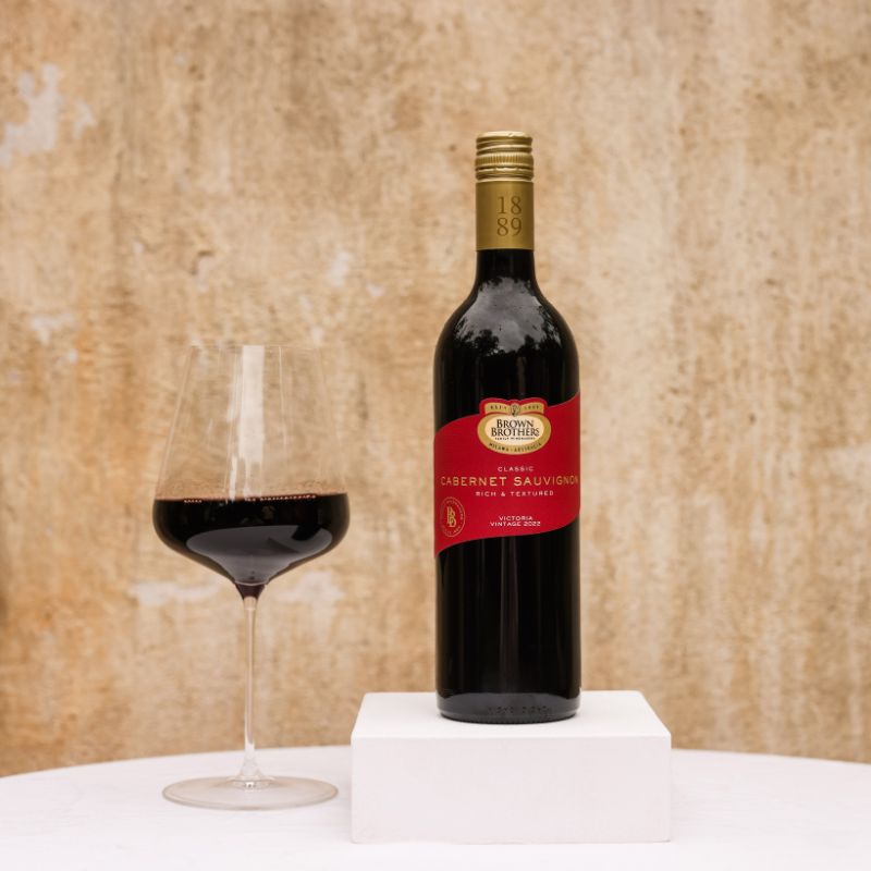 A bottle of Brown Brothers Cabernet Sauvignon with a glass of wine