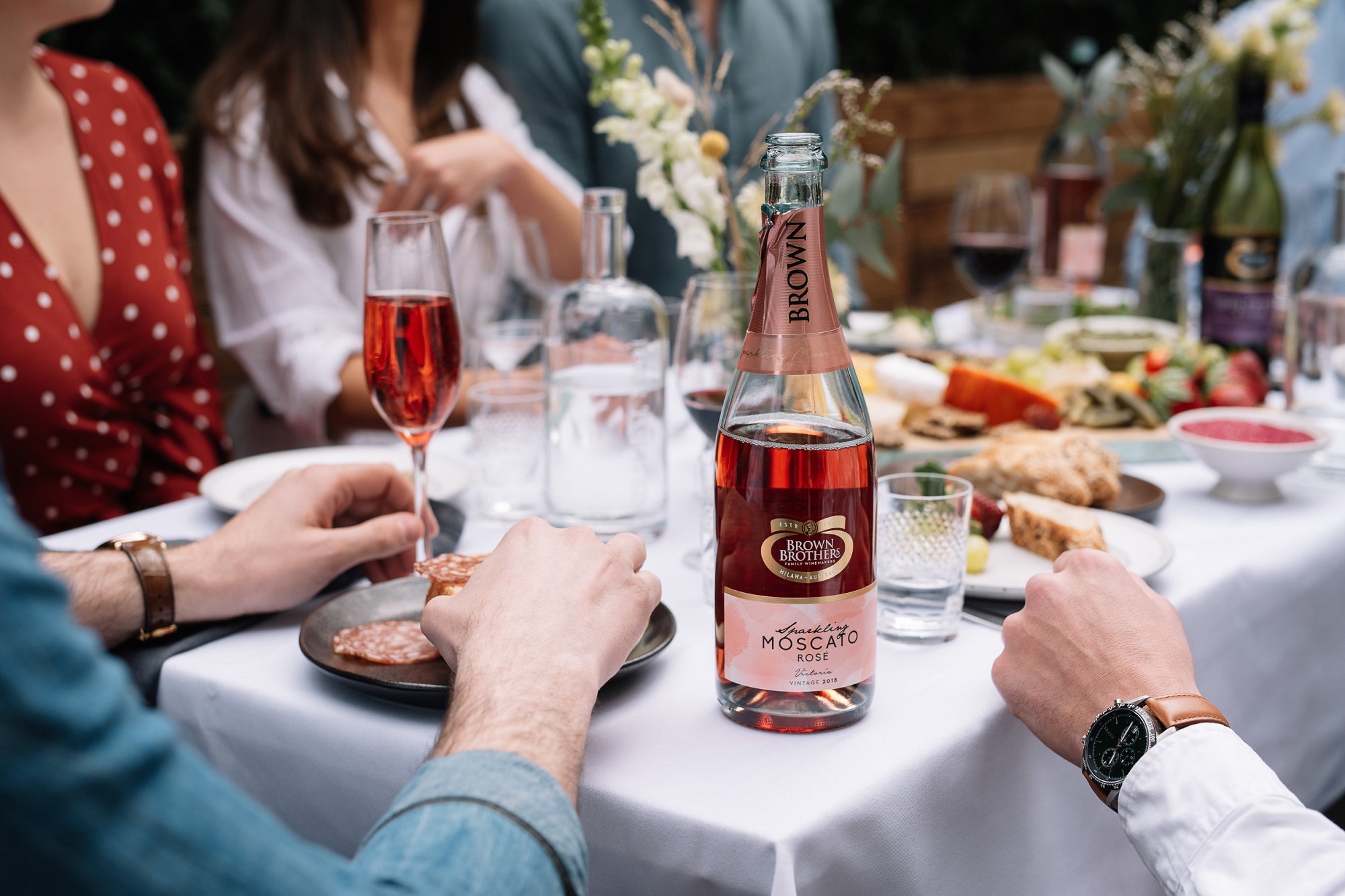 Sparkling Moscato Rose enjoyed alfresco at a dinner party with friends