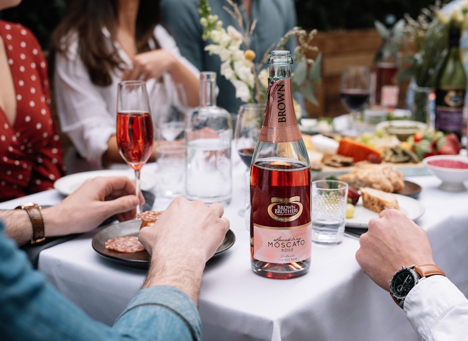 Sparkling Moscato Rose enjoyed alfresco at a dinner party with friends