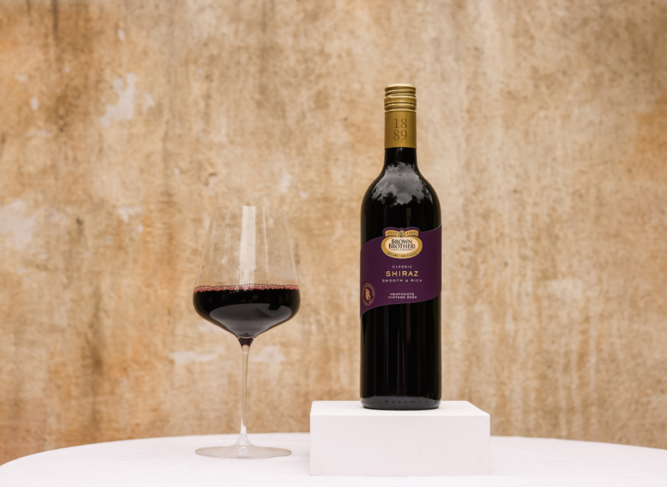A bottle of Brown Brothers Classic Shiraz with a glass of wine