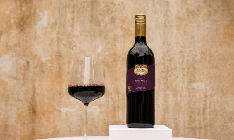 A bottle of Brown Brothers Classic Shiraz with a glass of wine