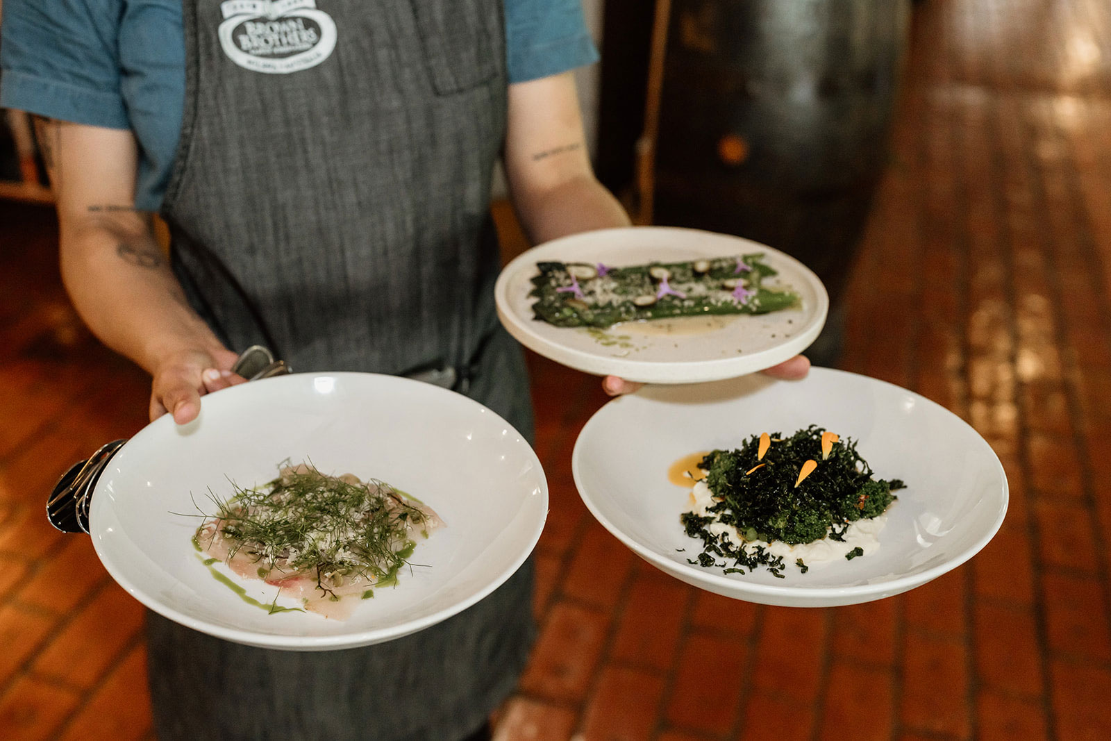 Restaurant staff holding plates of food for set menu